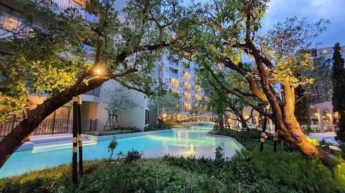 a swimming pool in front of a building at Lacasita Near Beach Huahin (Room564) in Hua Hin