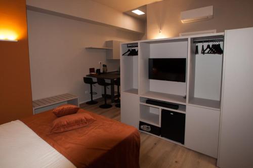 a bedroom with a bed and a flat screen tv at Hotel Ca' di Gali in Sasso Marconi