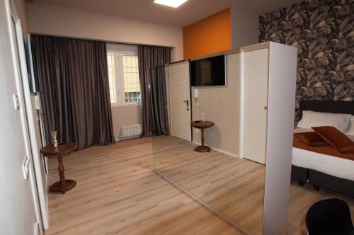 a room with a bedroom with a bed and a television at Hotel Ca' di Gali in Sasso Marconi