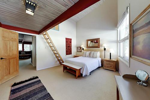 a bedroom with a bed and a staircase in it at Sierra Del Sol 6 in Taos Ski Valley