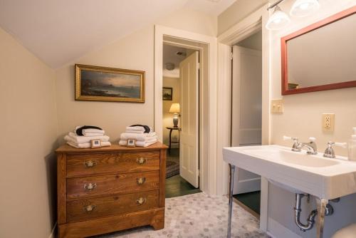 a bathroom with a sink and a wooden dresser at Inn at Valley Farms in Walpole