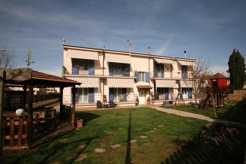 a large building with a playground in front of it at Azzurra ideale per famiglie in Donoratico