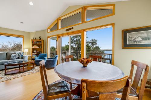a living room with a table and chairs at Escape to the Cape in Tillamook