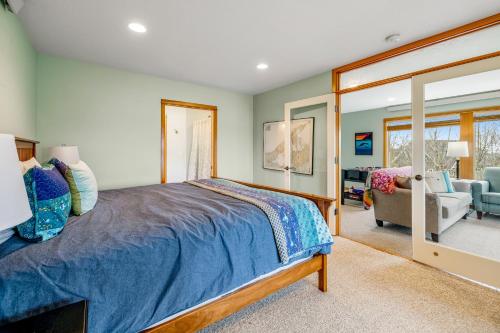 a bedroom with a bed and a living room at Escape to the Cape in Tillamook