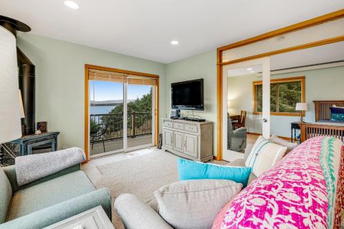 a living room with a couch and a tv at Escape to the Cape in Tillamook