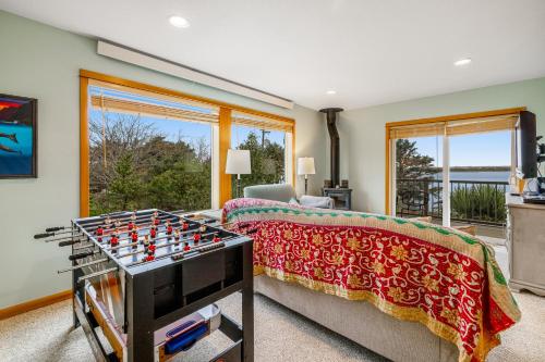 a living room with a chess board on a bed at Escape to the Cape in Tillamook