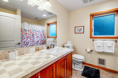 a bathroom with a sink and a toilet at Escape to the Cape in Tillamook