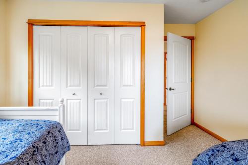 a bedroom with two beds and two doors at Escape to the Cape in Tillamook