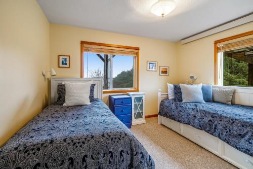 a bedroom with two beds and a window at Escape to the Cape in Tillamook