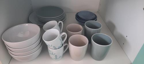 a group of cups and plates in a drawer at La vache au lit in Damme