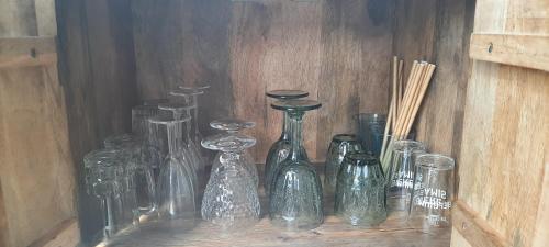 a group of glass bottles sitting on a shelf at La vache au lit in Damme