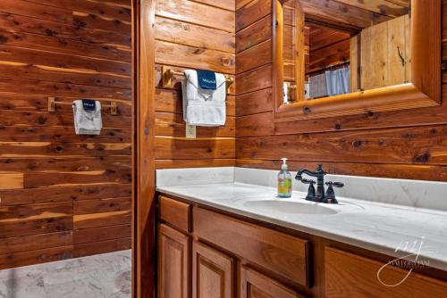 a bathroom with a sink and a mirror at Fly Away Cabin- Modern, Serene, And Convenient in Compton
