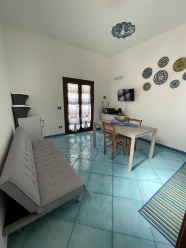 a living room with a couch and a table at Le Casette Sul Lungomare in Sciacca