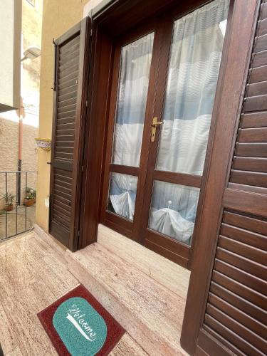 a door with a welcome mat in front of it at Le Casette Sul Lungomare in Sciacca