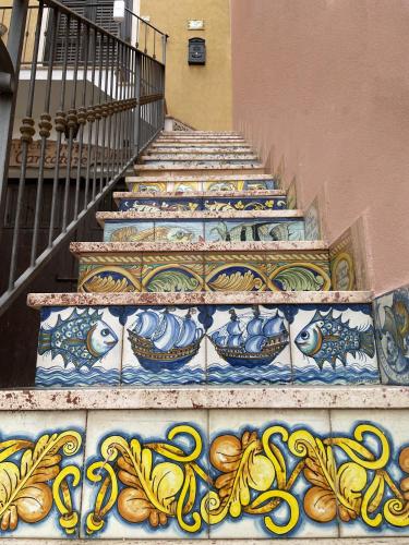 a set of stairs with colorful tiles on them at Le Casette Sul Lungomare in Sciacca