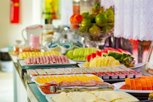 a buffet with different types of food on a table at Pousada Polymar in Maragogi
