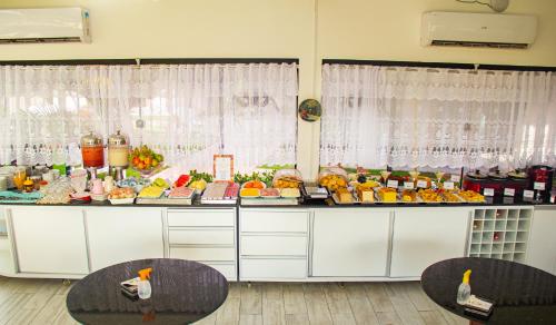 a buffet with many different types of food and drinks at Pousada Polymar in Maragogi