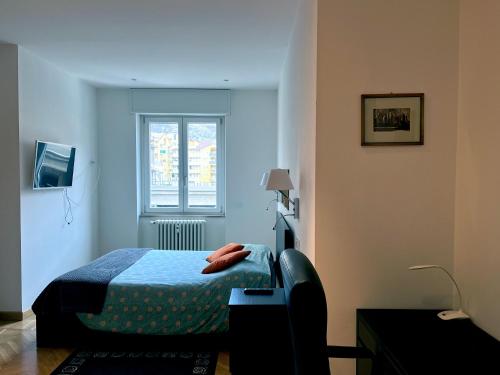 a small bedroom with a bed and a window at The Lighthouse - Central Apartment Aosta - cir 0234 in Aosta