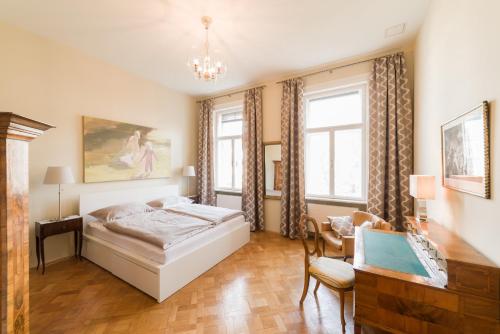 a bedroom with a bed and a chair at Sissi - Schoenbrunn-Living perfect Apartments in Vienna