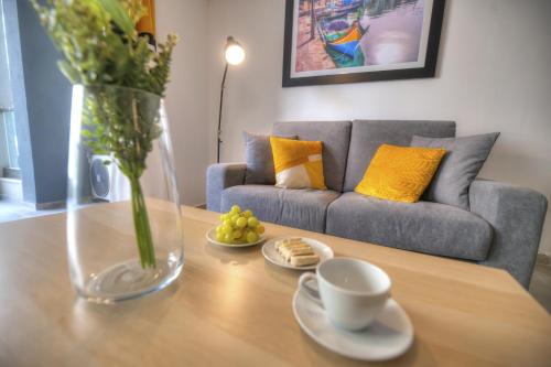 a living room with a table and a couch at Bright and beautifully furnished apartment close to seafront BFRA1-2 in Il-Gżira