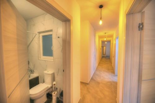 a bathroom with a toilet and a hallway at Bright and beautifully furnished apartment close to seafront BFRA1-2 in Il-Gżira