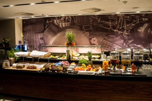 a buffet line with many different types of food at Holiday Inn Łódź by IHG in Łódź