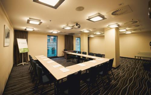 a conference room with a long table and chairs at Holiday Inn Łódź by IHG in Łódź