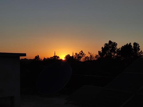 a sunset from the backyard of a house at Sunrise Rest House in Islamabad