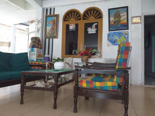 ein Wohnzimmer mit 2 Stühlen und einem Sofa in der Unterkunft Kenangan Guest House in Sabang