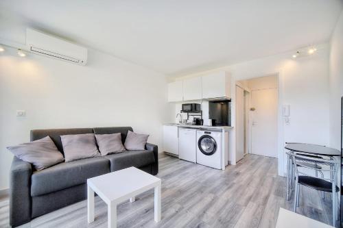 un salon avec un canapé et une table dans l'établissement IMMOGROOM - Pool - Terrace - Parking - Air conditioning - NO WIFI, à Cannes