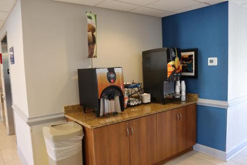a room with a counter with a coffee maker at Microtel Inn & Suites by Wyndham Columbus Near Fort Moore in Columbus