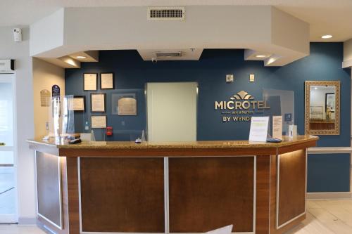 a lobby of a mhotel by warriott hotel at Microtel Inn & Suites by Wyndham Columbus Near Fort Moore in Columbus