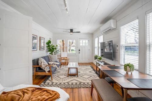 a living room with a couch and a table at Historic Heights Artist Boho Bungalow in Houston