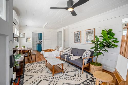 a living room with a couch and a table at Historic Heights Artist Boho Bungalow in Houston