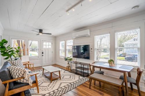 a living room with a couch and a table at Historic Heights Artist Boho Bungalow in Houston