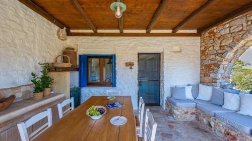 a living room with a table and a couch at BLUE GREENS VILLAS in Kampos Paros