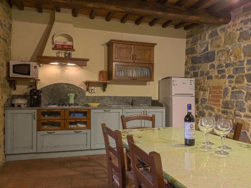 a kitchen with a table with wine glasses on it at Apartment Boccaccio by Interhome in San Donato in Poggio