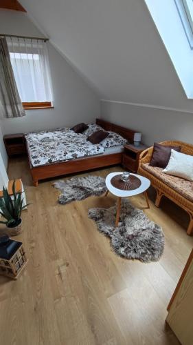 a living room with two beds and a table at Iva ubytovanie in Liptovský Mikuláš