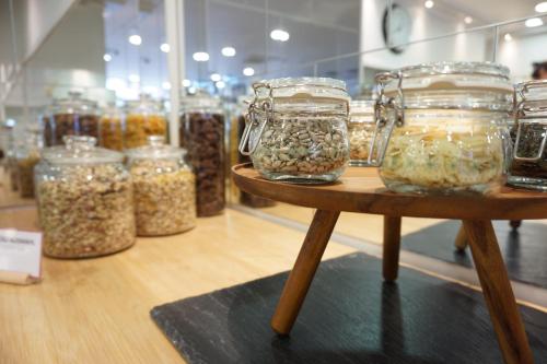 a display of jars of nuts and seeds on a table at Hotel Kaffeemühle in Vienna