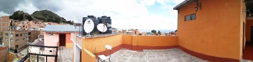 a view of a city with a clock on the side of a building at Hostal Puerto Alegre in Copacabana