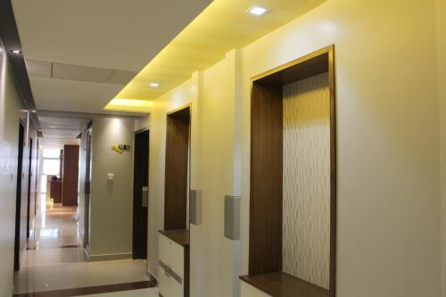 a hallway with a mirror on the wall at NAAS Serviced Apartments in Dhaka