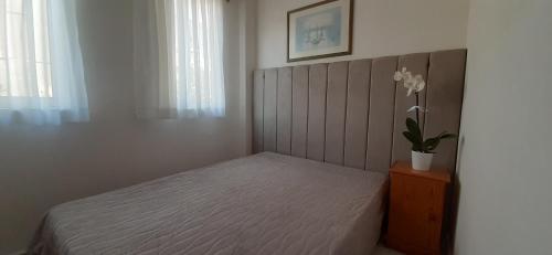 a bedroom with a bed and a vase of flowers at Mert Apart in Mugla