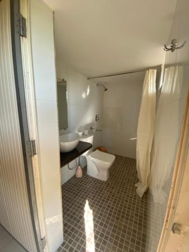 a bathroom with a toilet and a sink at Dmellos Sea View Home in Candolim