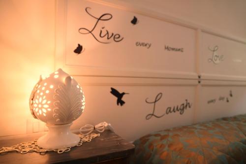a lamp on a table next to a bed at Le Stanze di Maria-Ingresso Autonomo Maria's Rooms-Indipendent Entrance in Giovinazzo