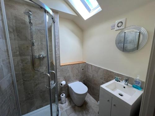a bathroom with a shower and a toilet and a sink at The Beresford Arms in Morpeth