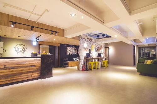 a large room with a bar and a restaurant at Ahiruyah Guesthouse in Kaohsiung