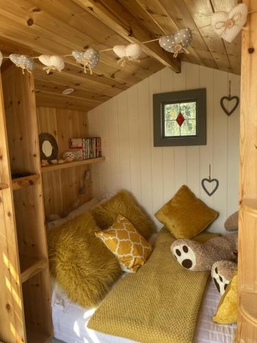 a room with two beds in a cabin with a window at Shepherd's Hut at St Anne's - Costal Location in Plymouth