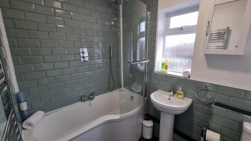 bagno con lavandino, vasca, servizi igienici e lavandino di Stockwood House by Cliftonvalley Apartments a Bristol