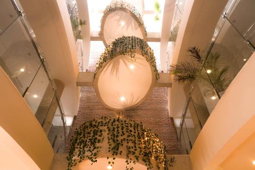 a large light fixture in a building with a spiral staircase at Chairu Eco Hotel in Santa Cruz de la Sierra