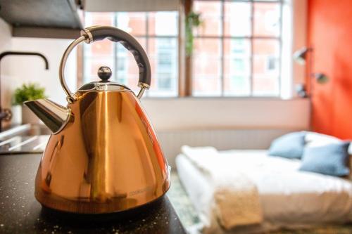 a yellow tea kettle sitting on a counter in a room at Lovely Central 1 Bed Apartment Sleeps 2 plus 1 in Sheffield